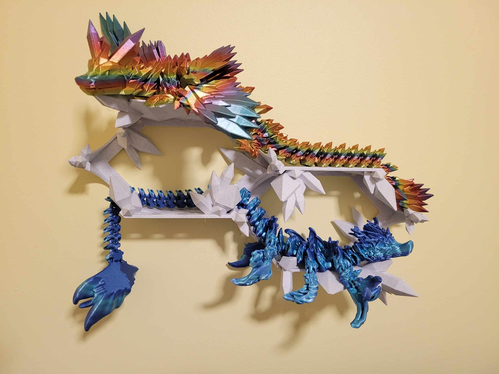 A crystal wall mount with colorful 3D-printed display pieces.